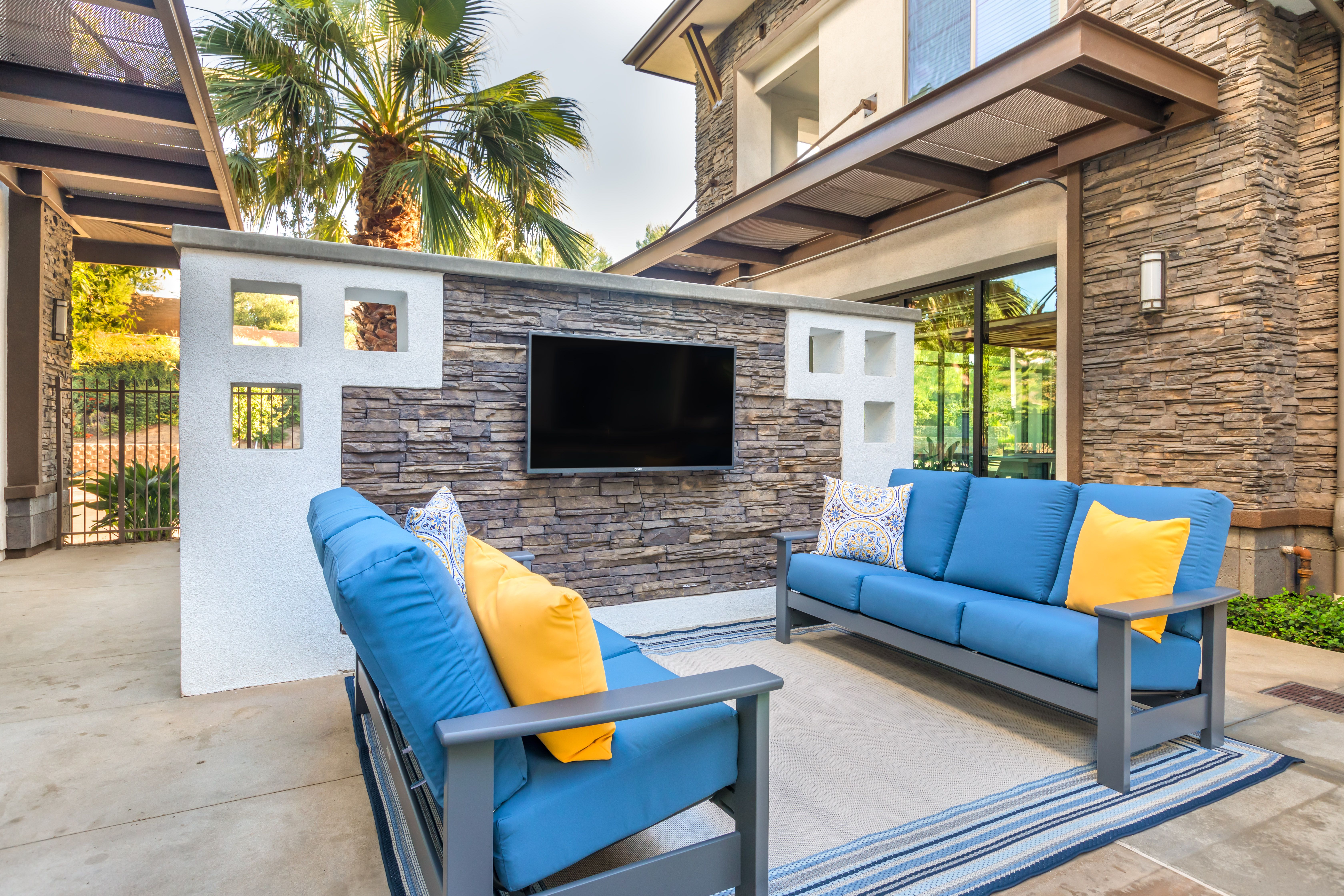 a living room with blue couches and a television